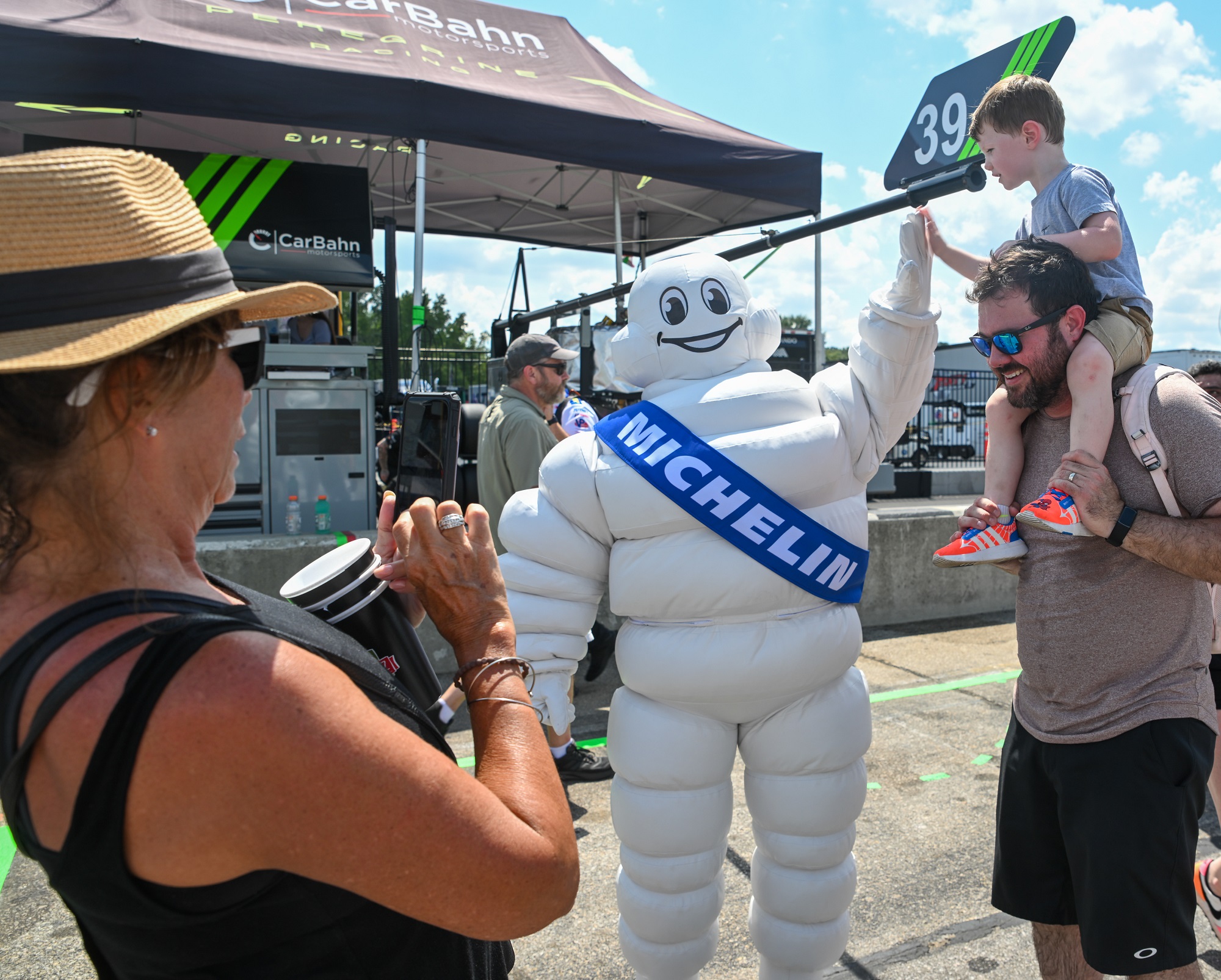 Fans giving a high five to the Michelin Man