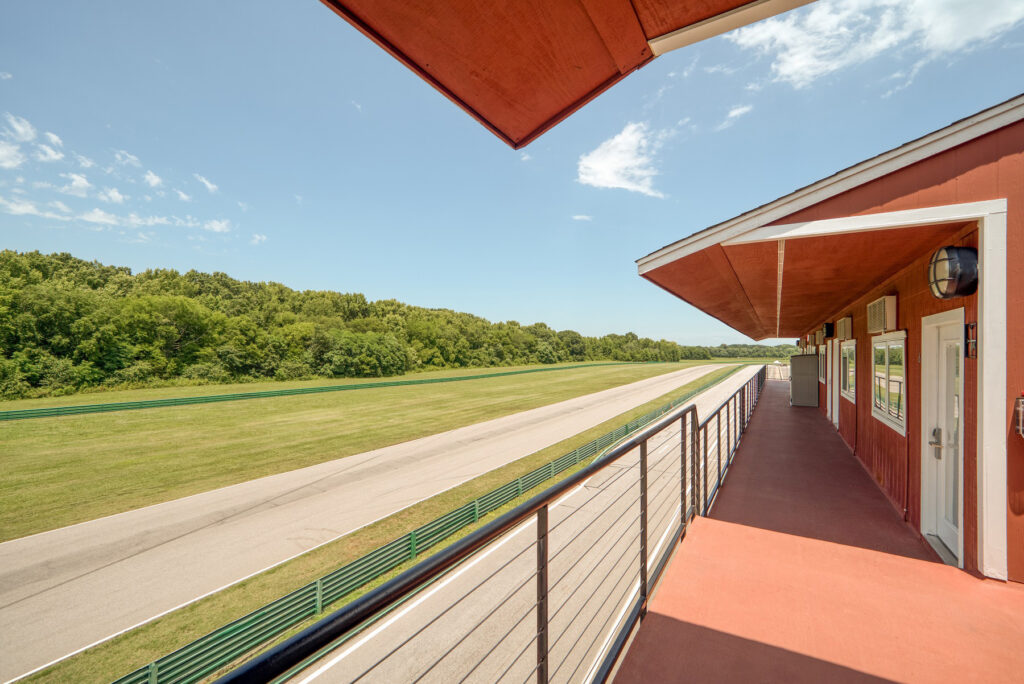 View from on top of pit lane garage's. Showing blue sky and front straight