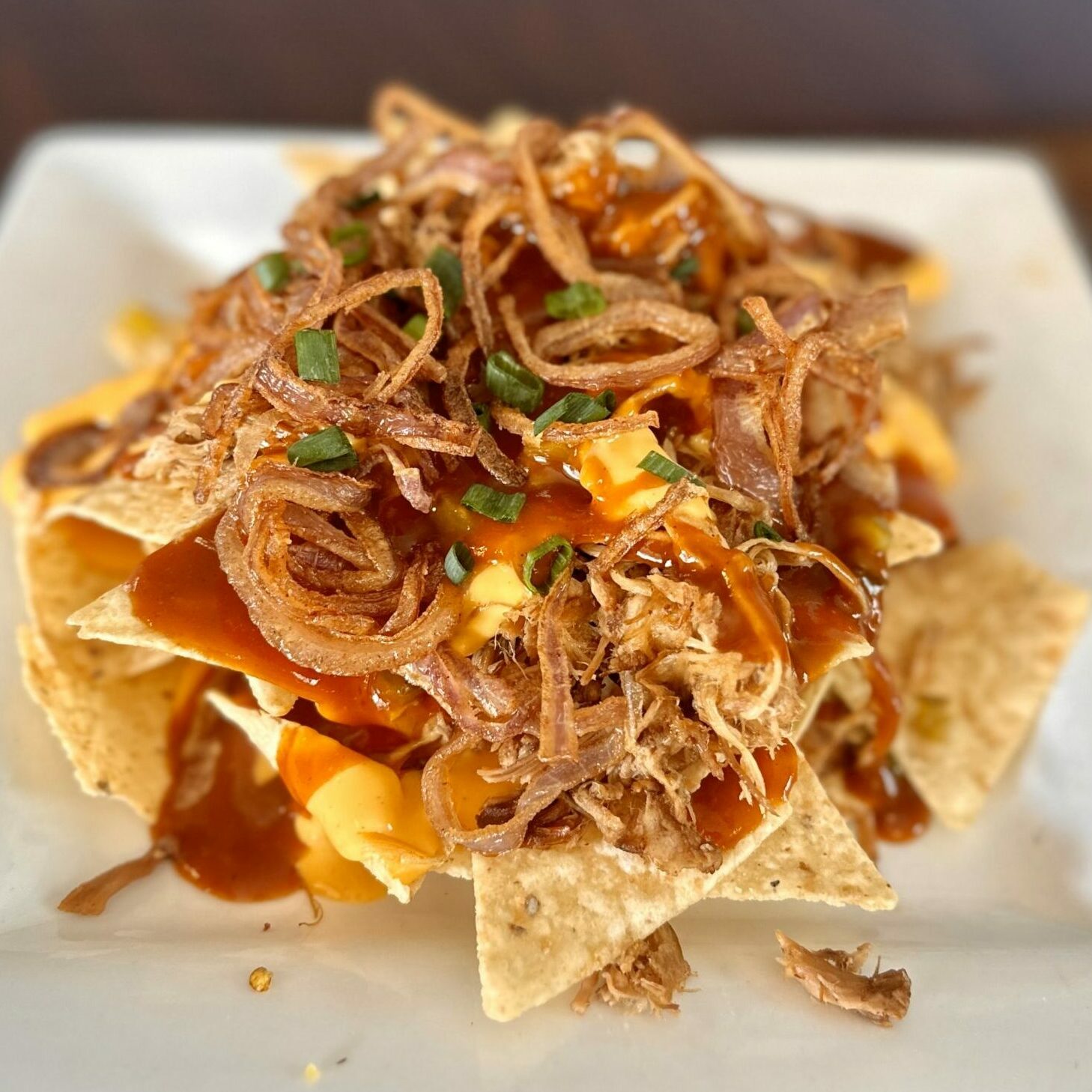 bbq chicken nachos on a white plate food