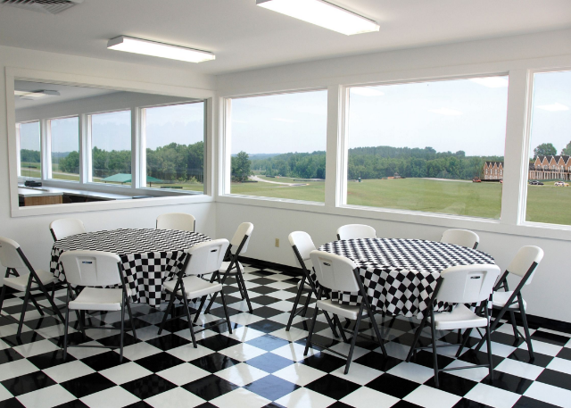 a room with a checkered floor and chairs