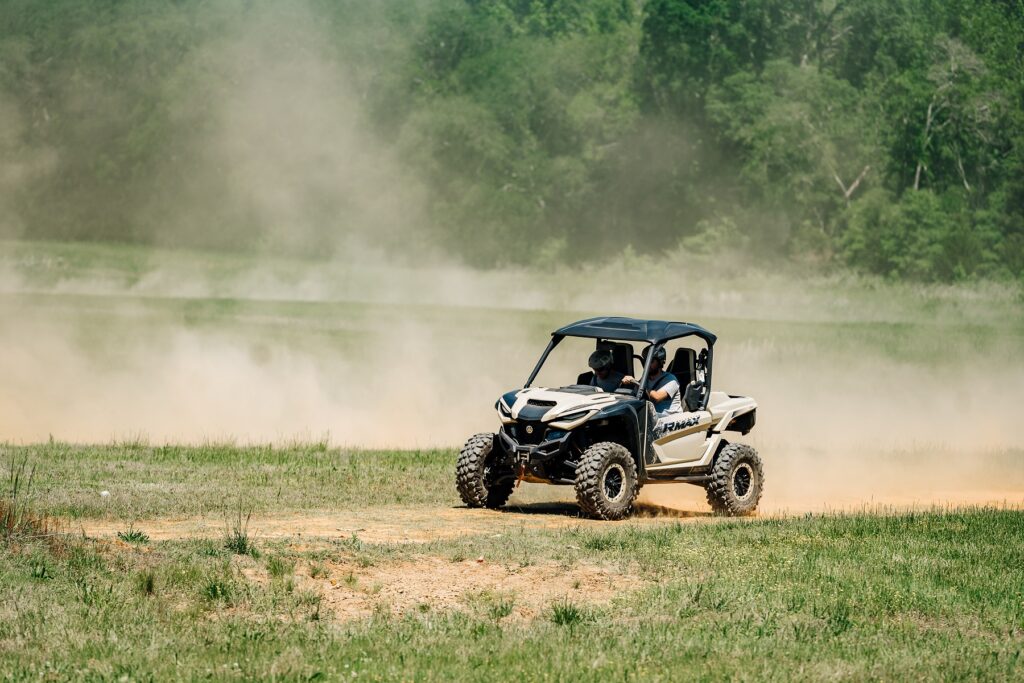 2 people off-roading an UTV vehicle