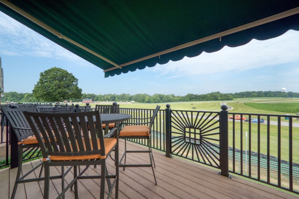 The back deck of the Villa, showing 4 chairs and a table