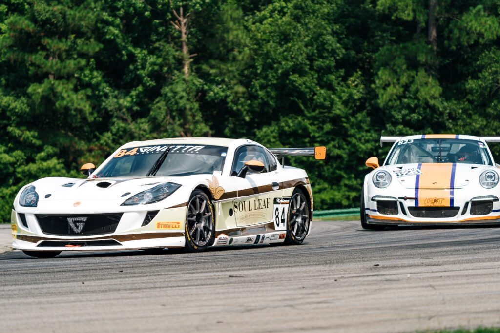 Ginetta race car and Porsche on track