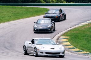 corvette, porsche, and bmw on track