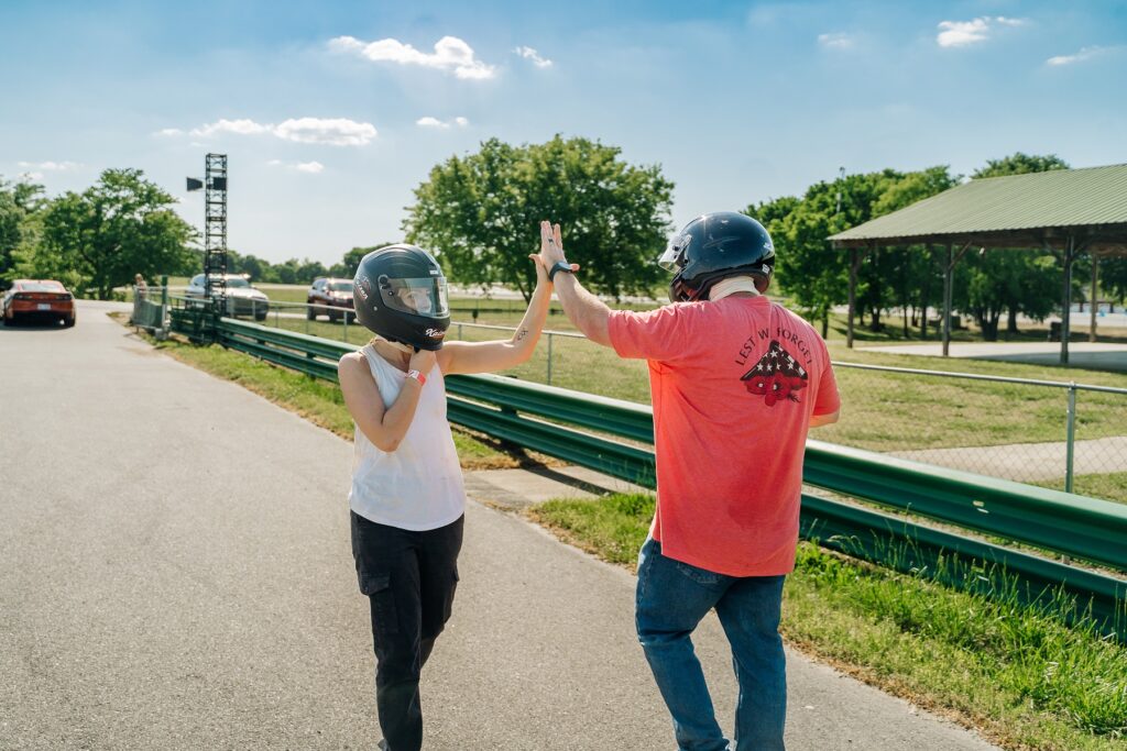 Two people high fiving on a bright sunny day