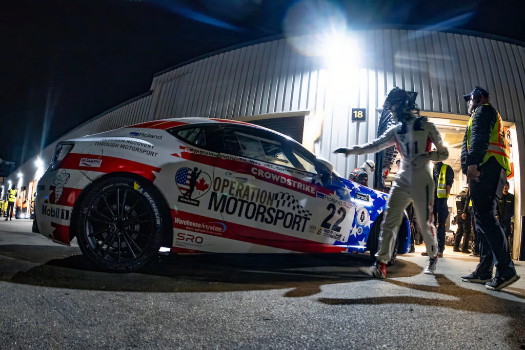 operation motorsport car at night in front of a garage