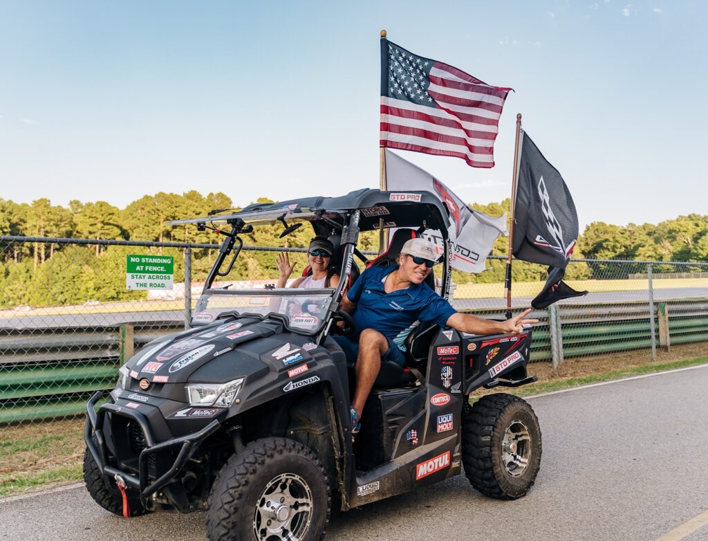 people on dark colored golf cart
